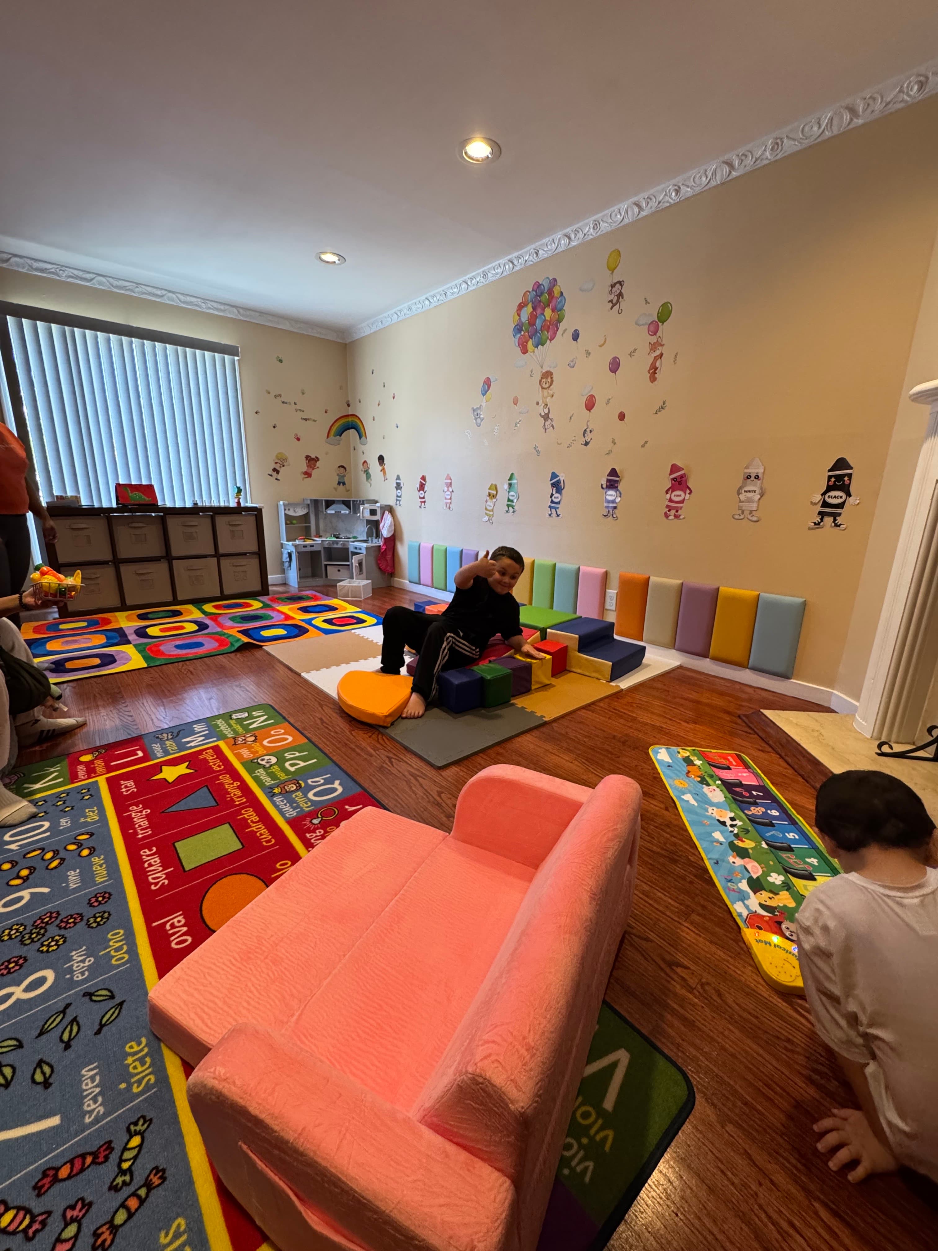 Indoor playroom with colorful foam mats and toys