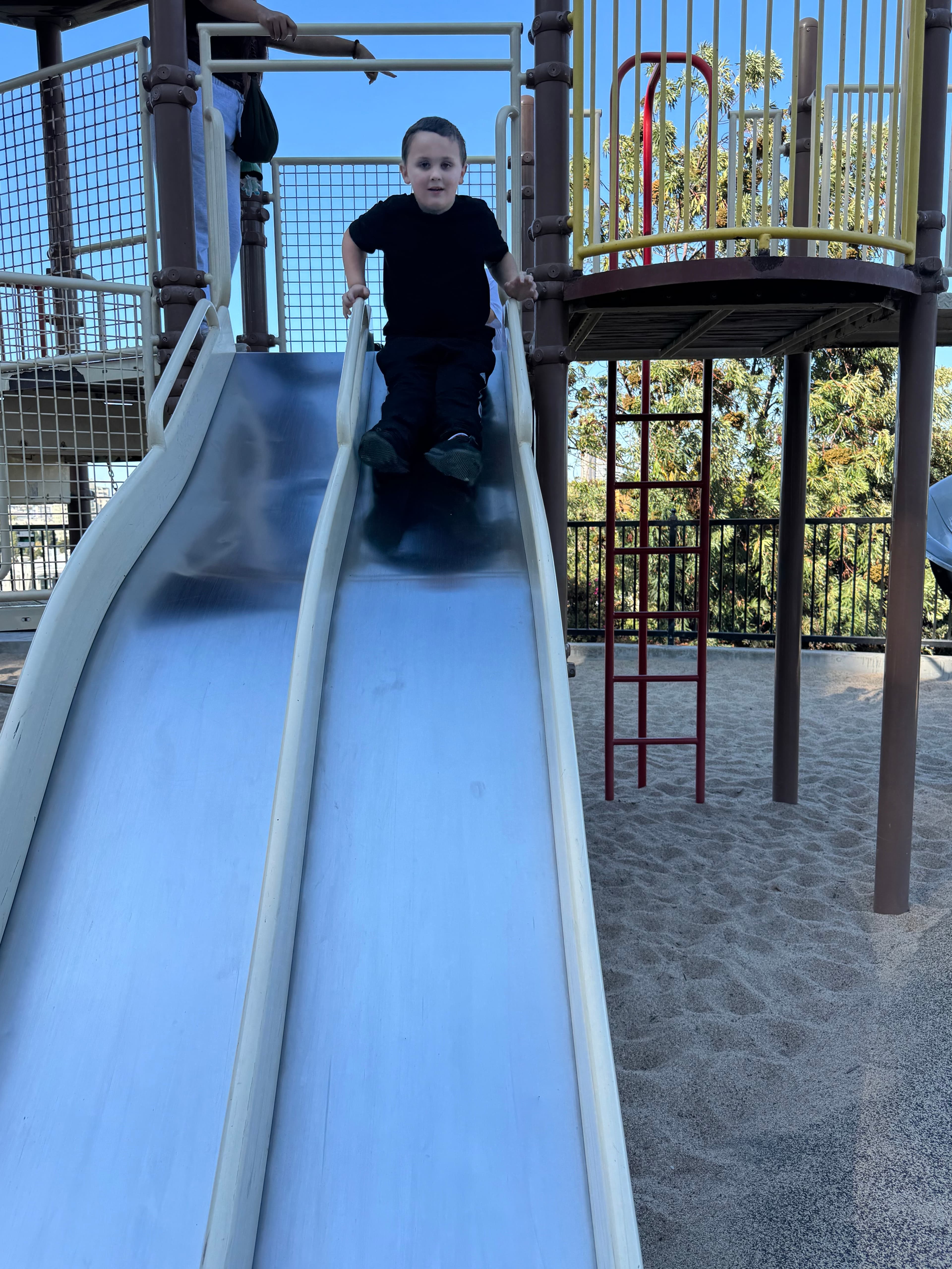 Child enjoying outdoor playground slide